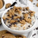 Chocolate chip cookie dip topped with crumbled cookies and mini chips.