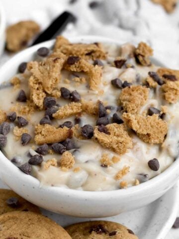 Chocolate chip cookie dip topped with crumbled cookies and mini chips