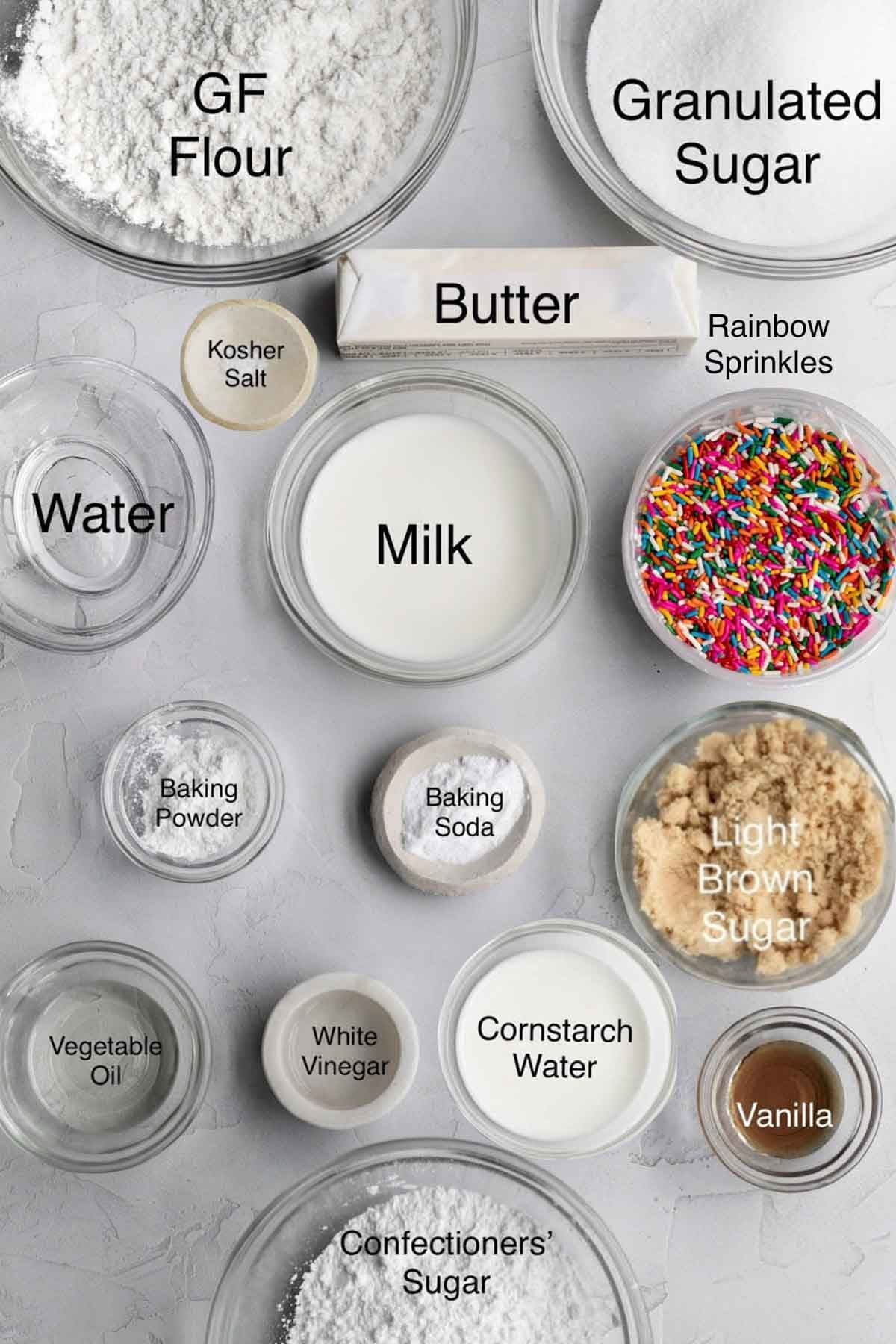 Eggless Vanilla Cake Ingredients: gluten free flour, granulated sugar, kosher salt, butter, water, milk, rainbow sprinkles, baking powder, baking soda, light brown sugar, vegetable oil, white vinegar, cornstarch water, vanilla and confectioners' sugar.