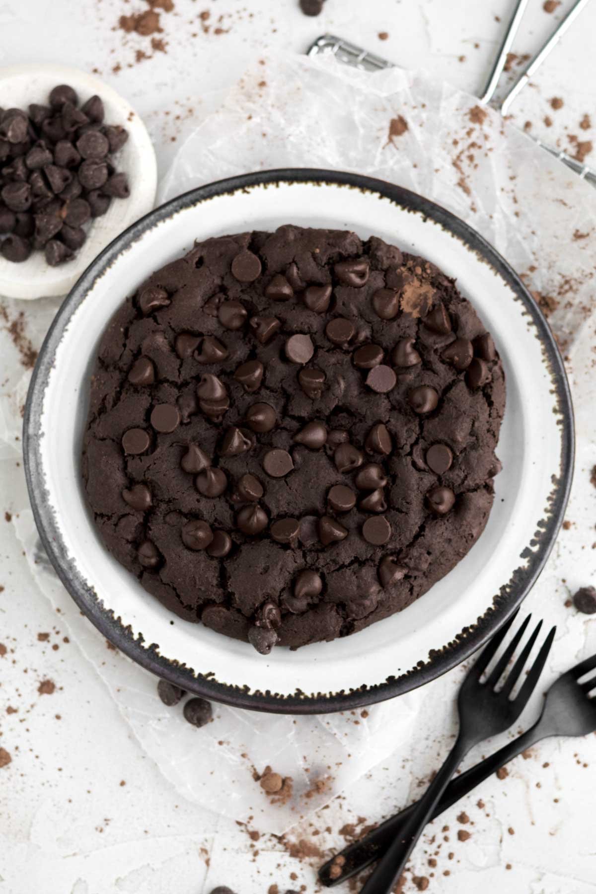 Thick bakery-style Giant Chocolate Cookie studded with semisweet chocolate chips on a plate.