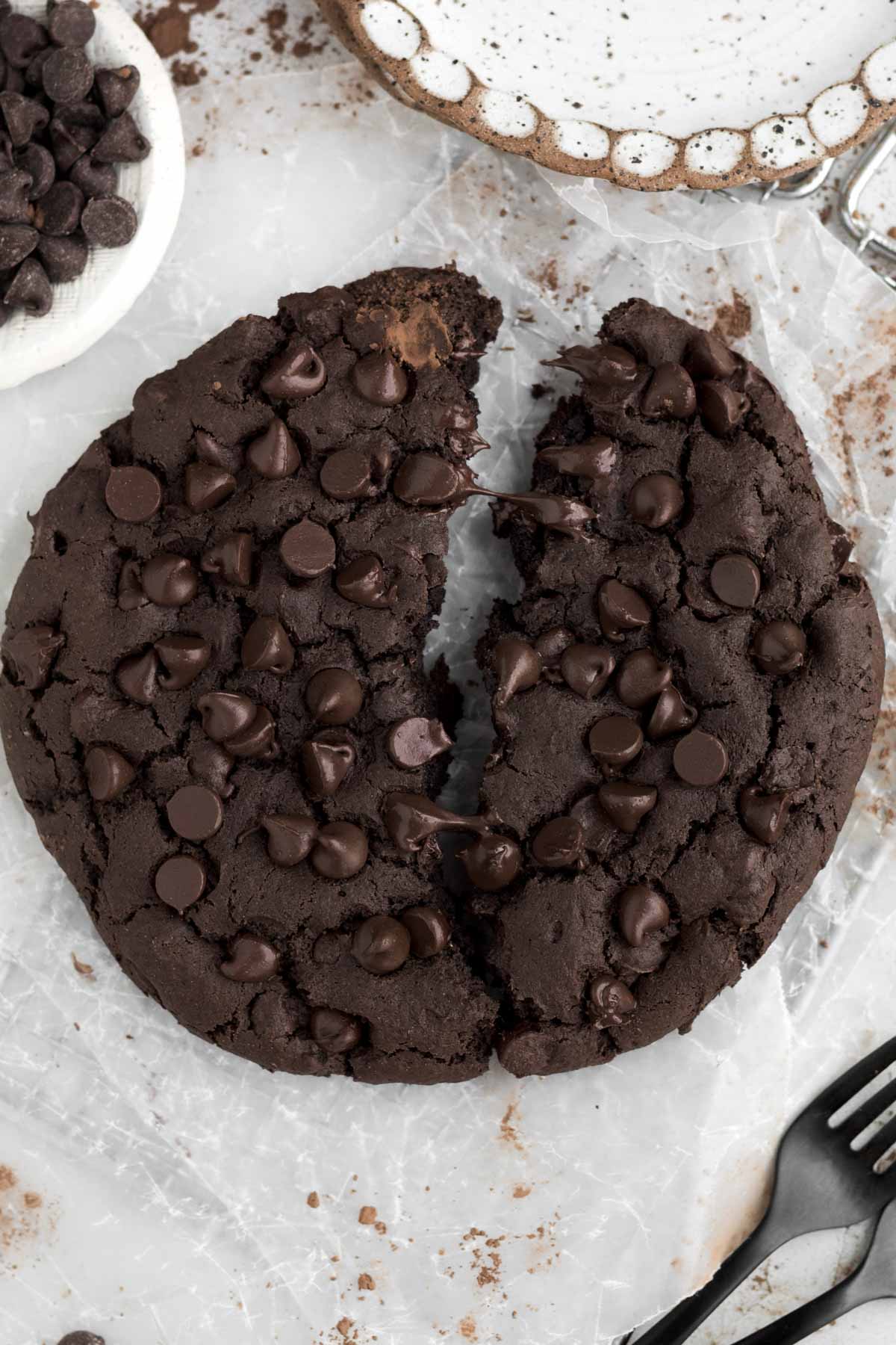 A splitting Giant Chocolate Cookie creates a chasm between the warm fudgy halves.