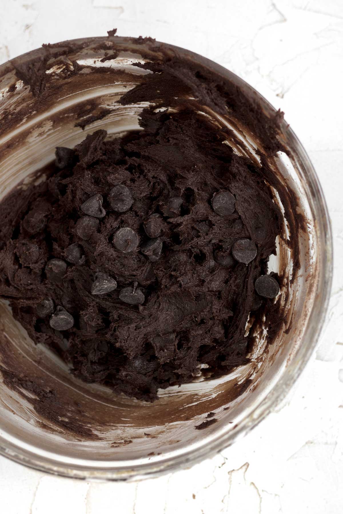 Combining the wet and dry ingredients and then adding the chocolate chips.