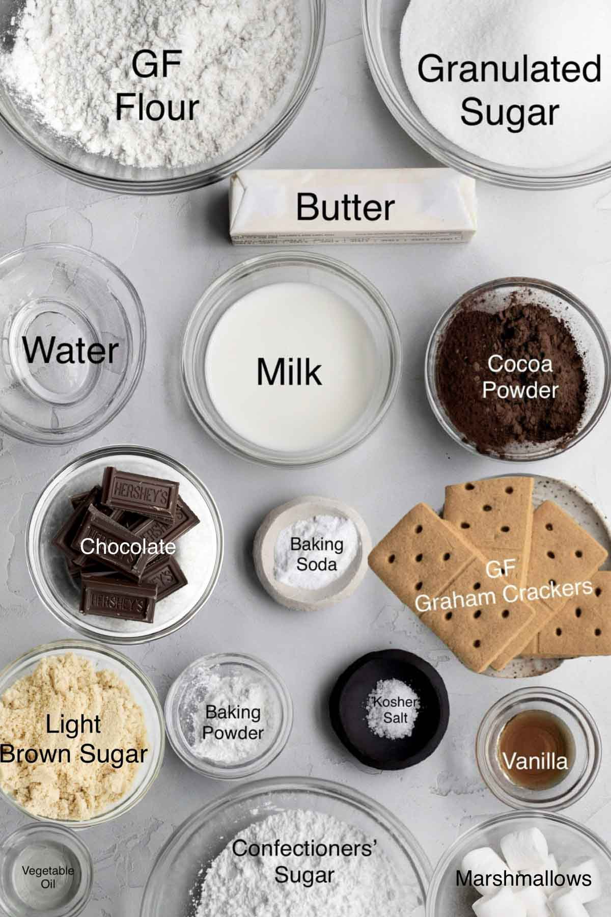 S'mores cupcakes ingredients: gluten free flour, granulated sugar, butter, water, milk, cocoa powder, chocolate, baking soda, gluten free graham crackers, light brown sugar, baking powder, kosher salt, vanilla, vegetable oil, confectioners' sugar, and marshmallows.
