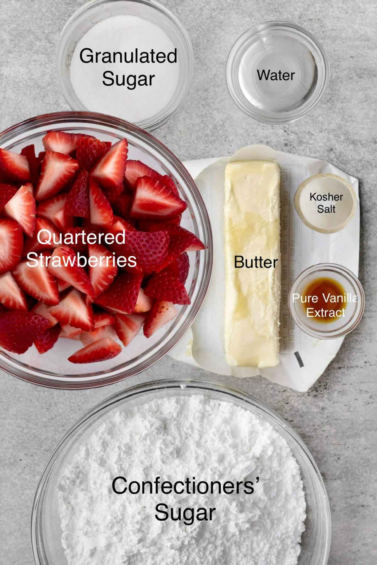 Strawberry buttercream ingredients: granulated sugar, water, quartered strawberries, butter, kosher salt, pure vanilla extract, and confectioners' sugar.