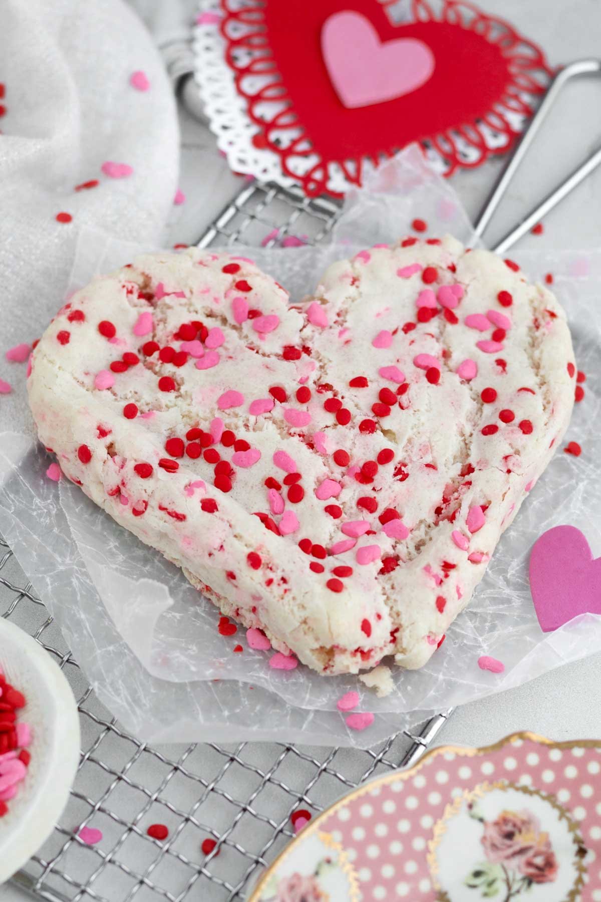 Large homemade Valentine’s Day Heart Cookie with romantic red and pink sprinkles.