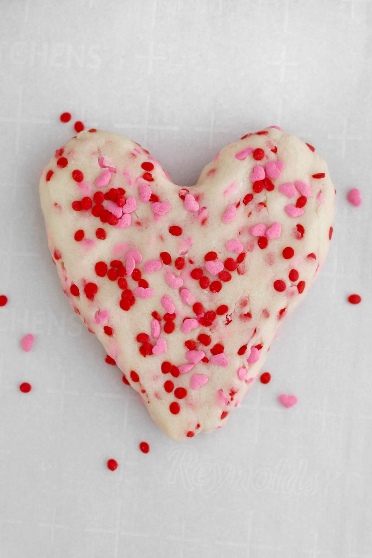 Cookie dough shaped into a heart with the heart sprinkles.