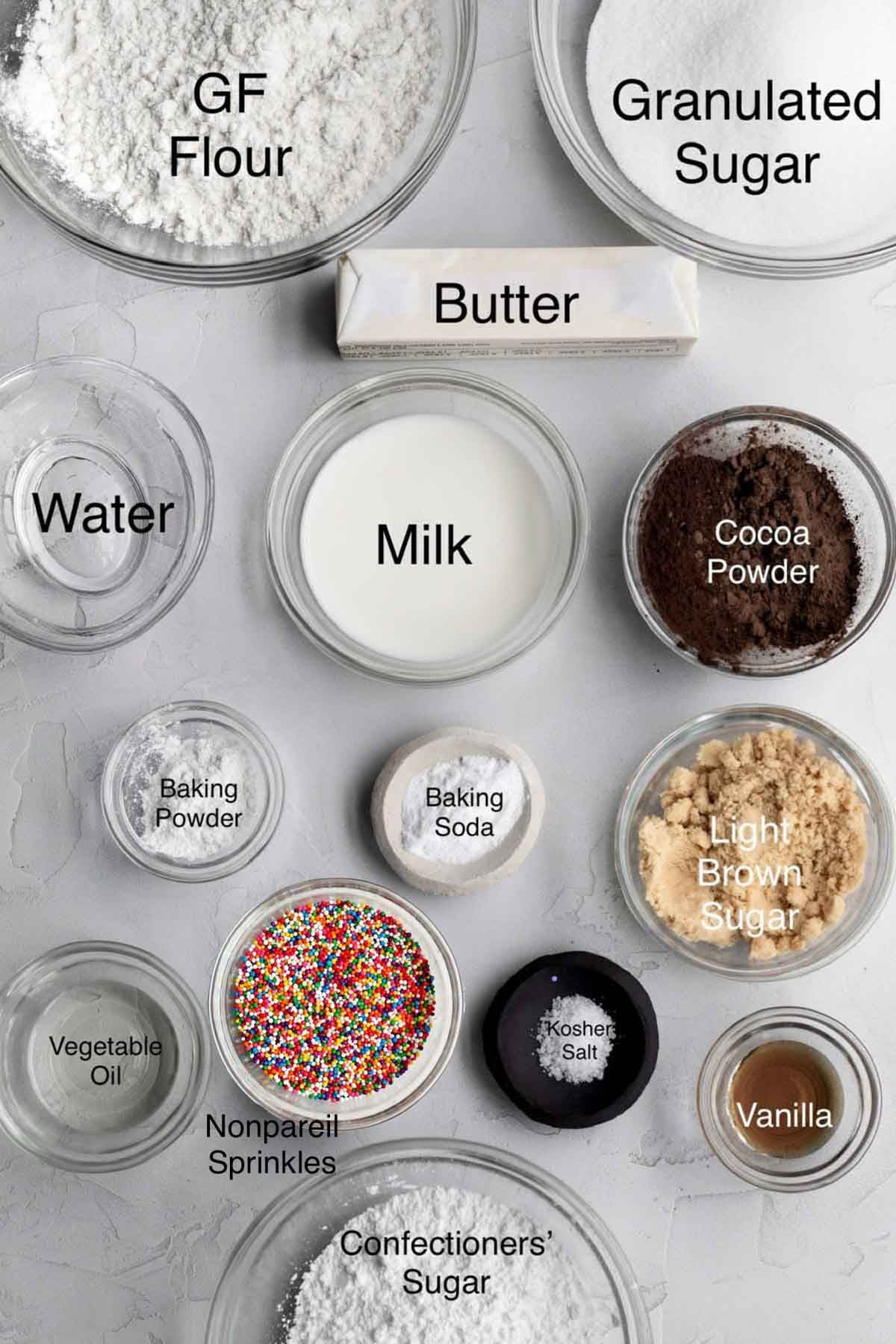 Yellow cake with chocolate frosting ingredients: gluten free flour, granulated sugar, butter, water, milk, cocoa powder, baking powder, baking soda, light brown sugar, vegetable oil, nonpareil sprinkles, kosher salt, vanilla and confectioners' sugar.