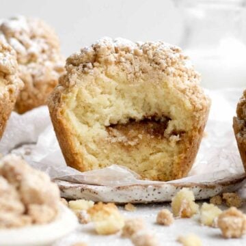 fresh-baked, gluten-free, coffee cake muffin broken open revealing a sweet cinnamon swirl center.