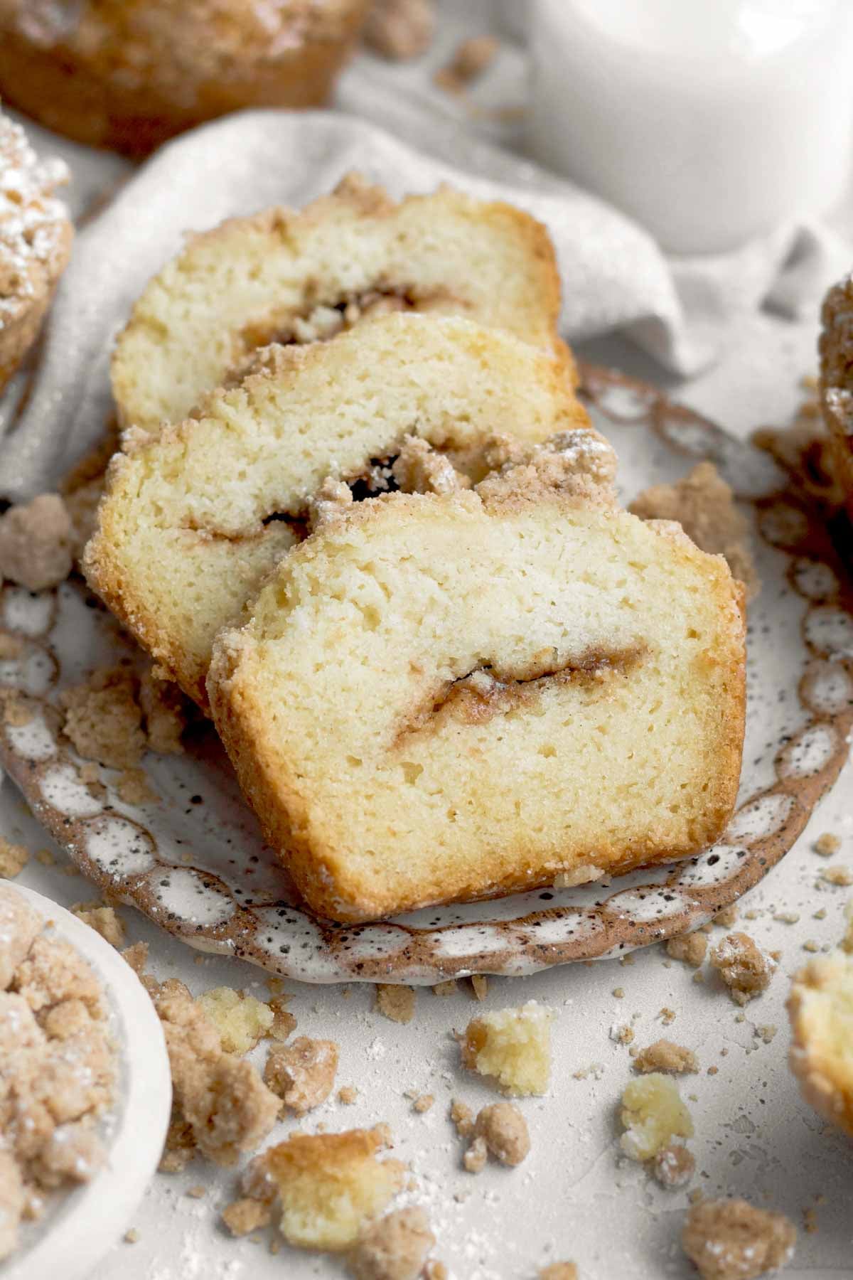 three textured, tender slices of coffee cake muffin with sugary cinnamon centers with buttery crumb tops.