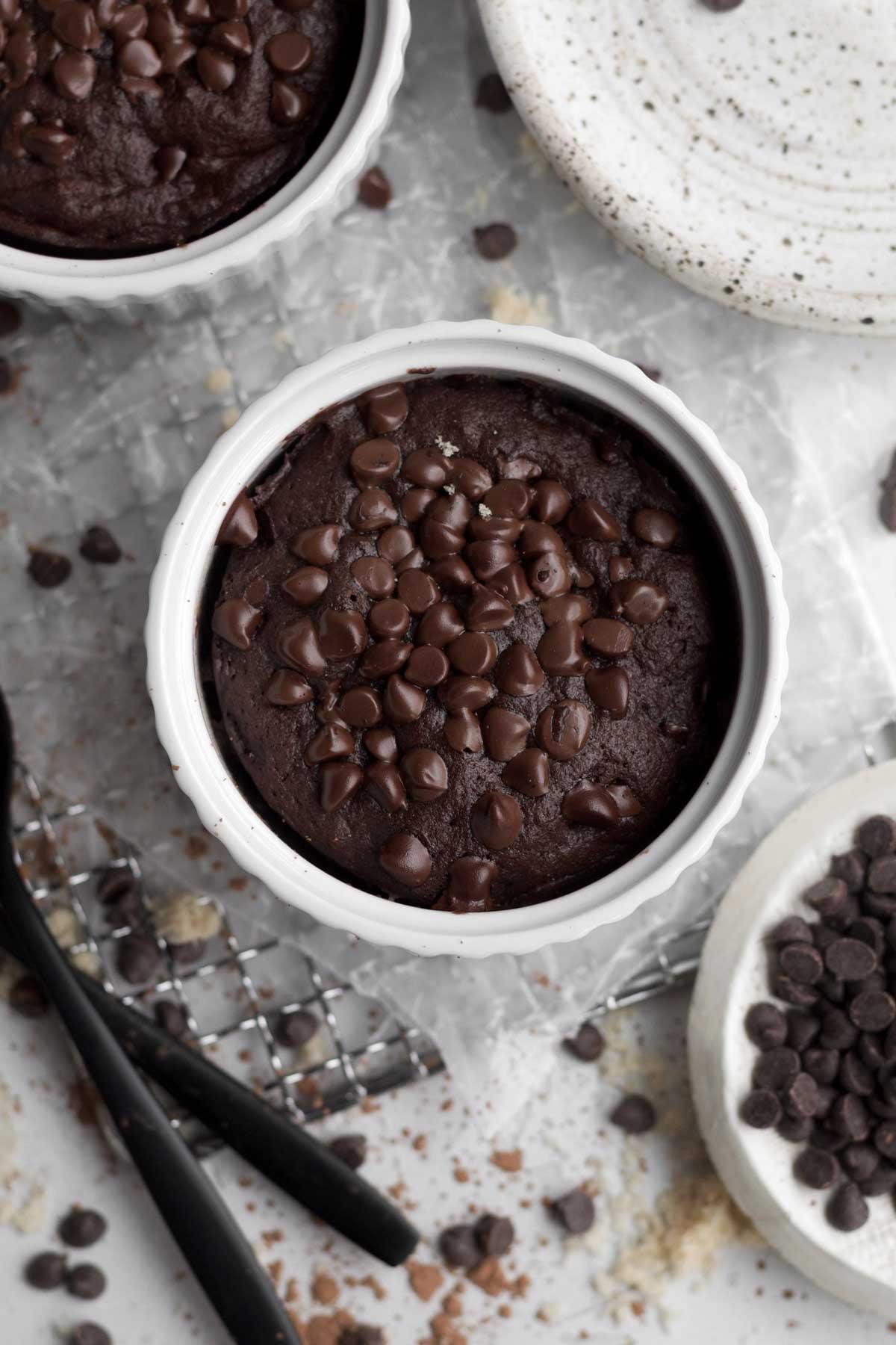 rich, gluten-free, easy chocolate mug cake topped with shiny slightly melted mini chocolate chips.