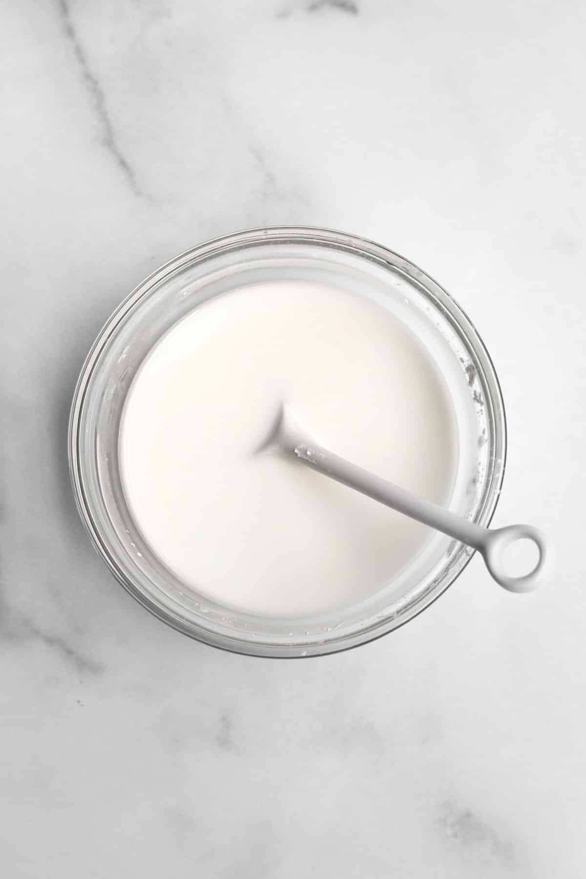 milky white cornstarch water with a spoon.