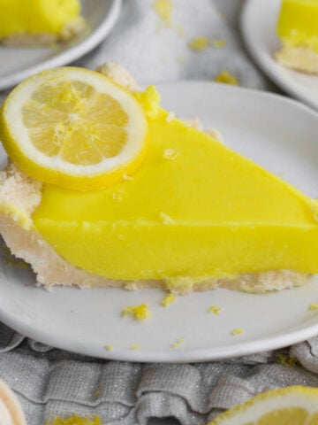 a perfect, tart, eggless lemon curd pie slice with golden sandwich cookie crust.