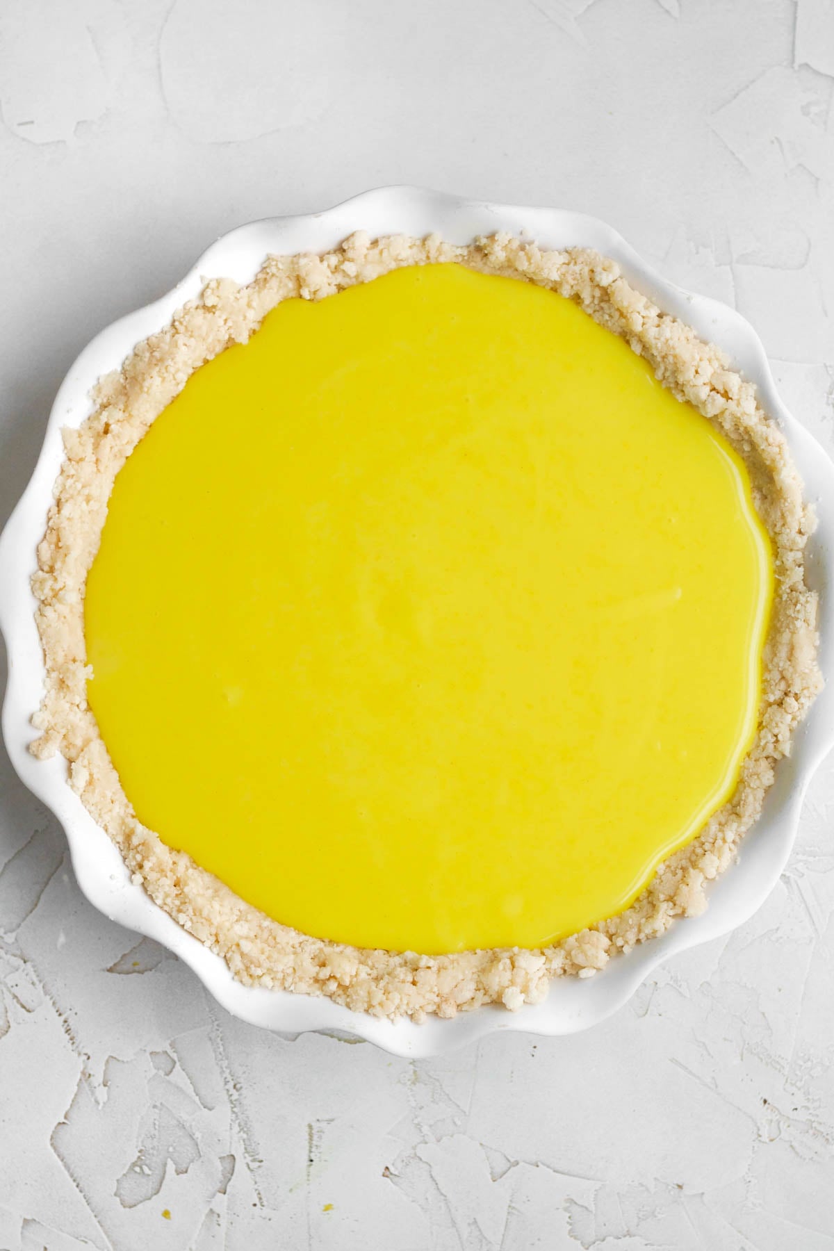 filling the crusted pie dish with the curd.