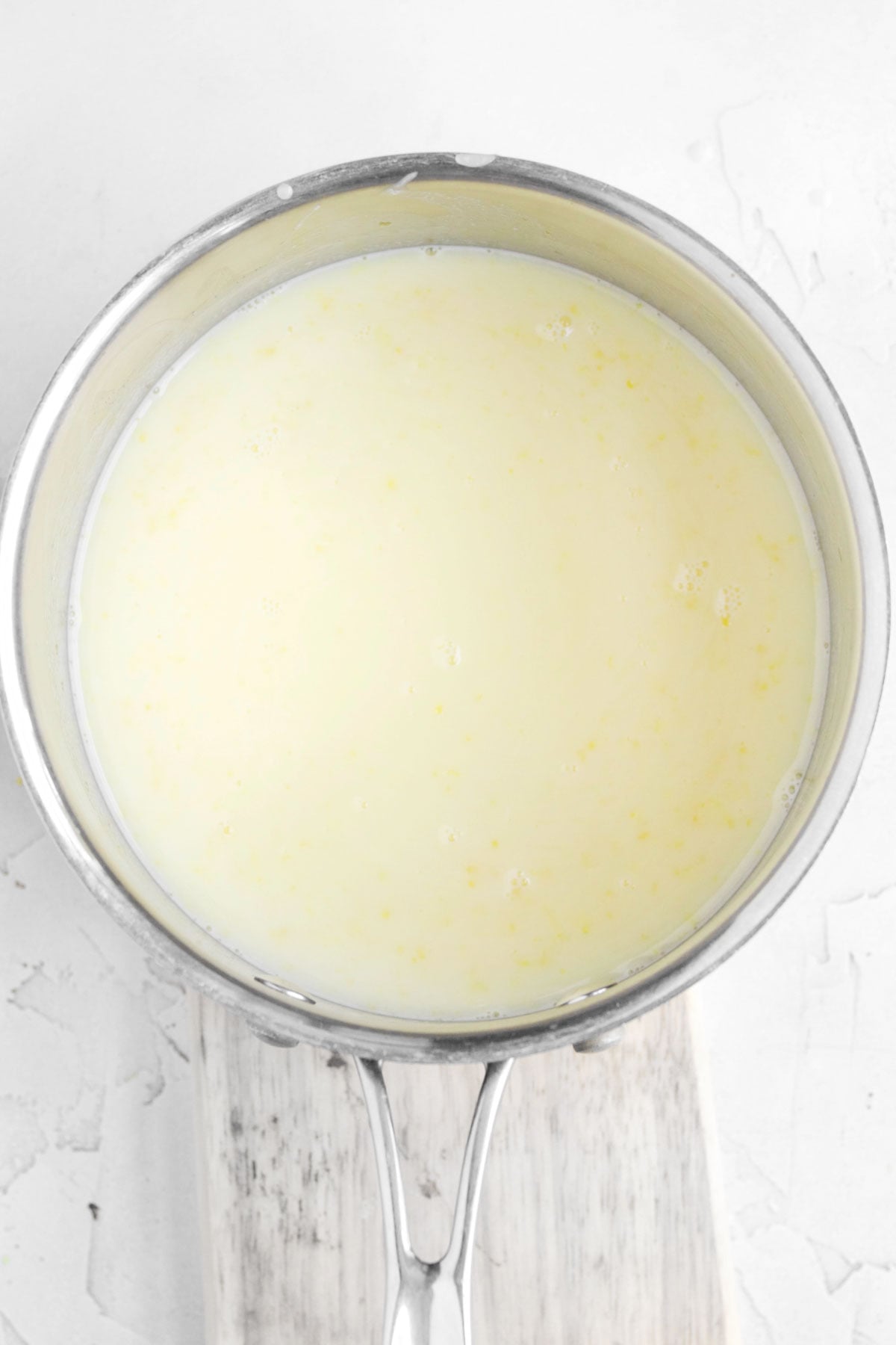 a saucepan with the heated heavy cream, lemon juice, lemon zest and sugar.