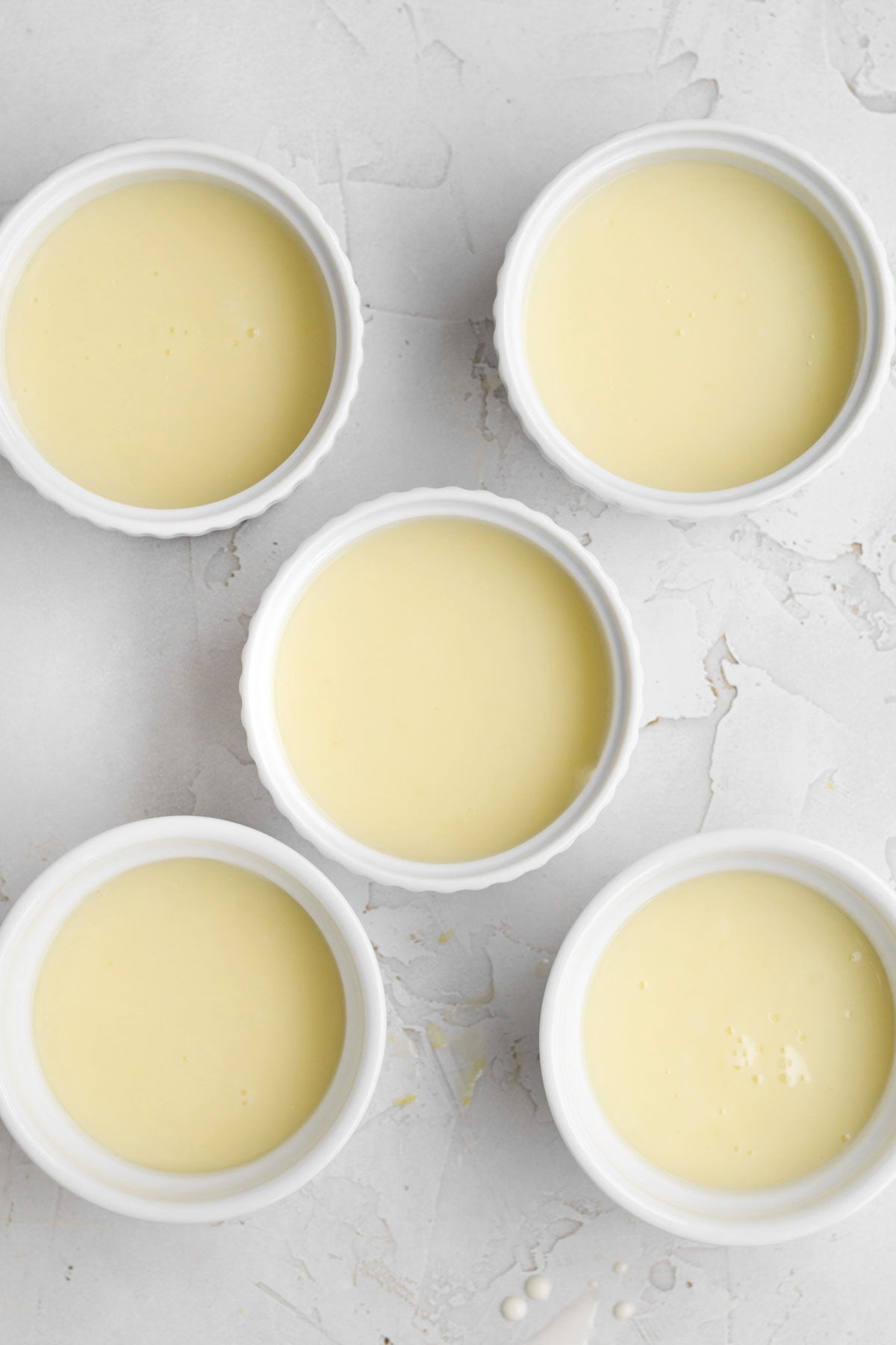 five ramekins filled with lemon posset.