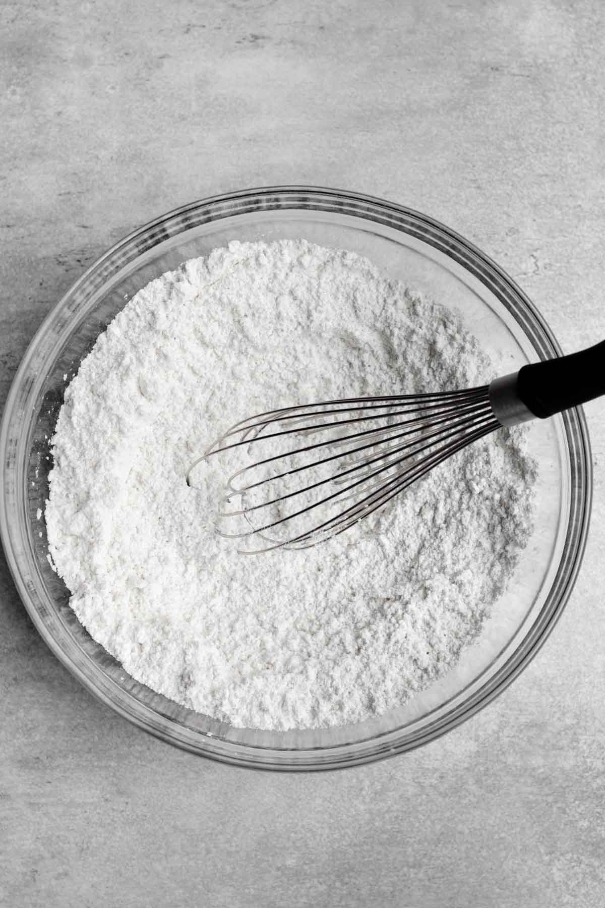 A whisk with the white dry ingredients.