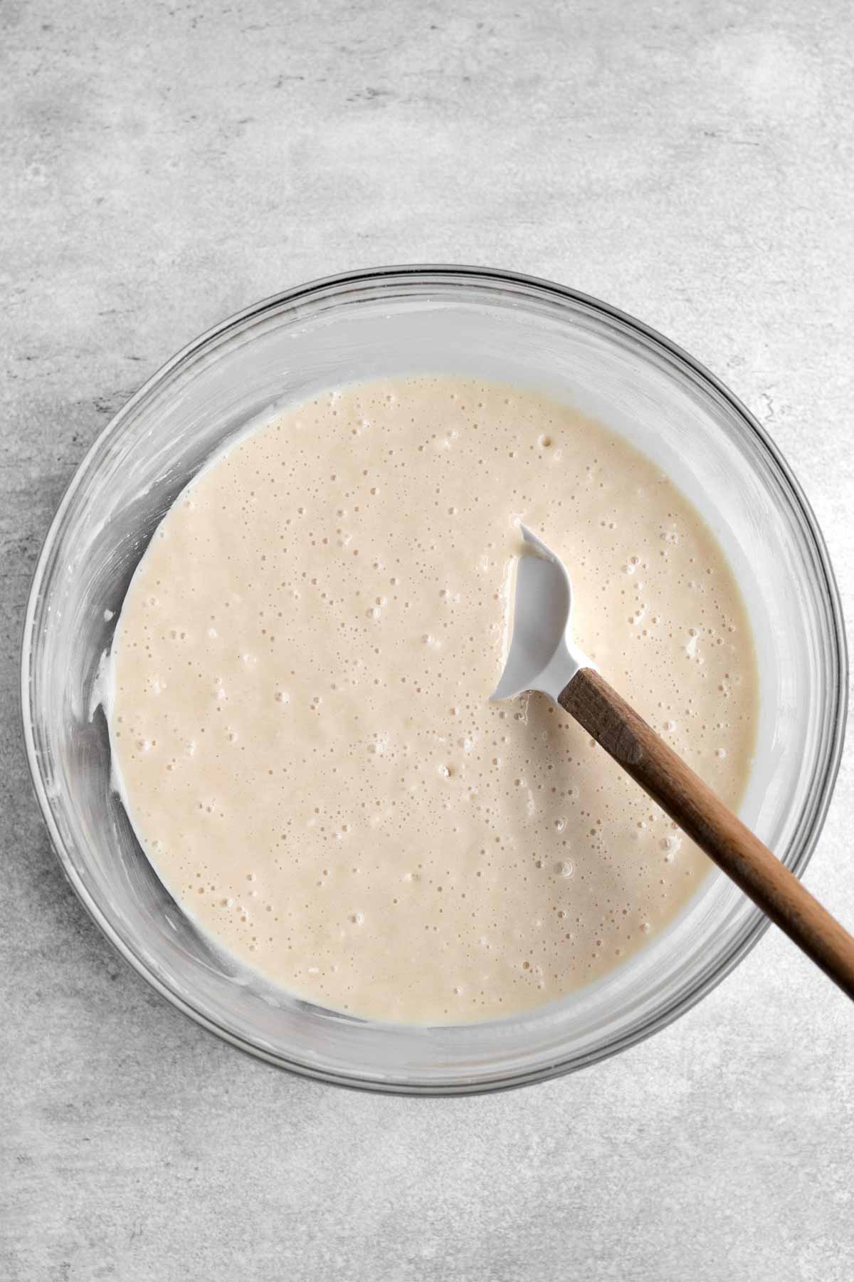 Mixing the wet and dry ingredients into a cake batter.
