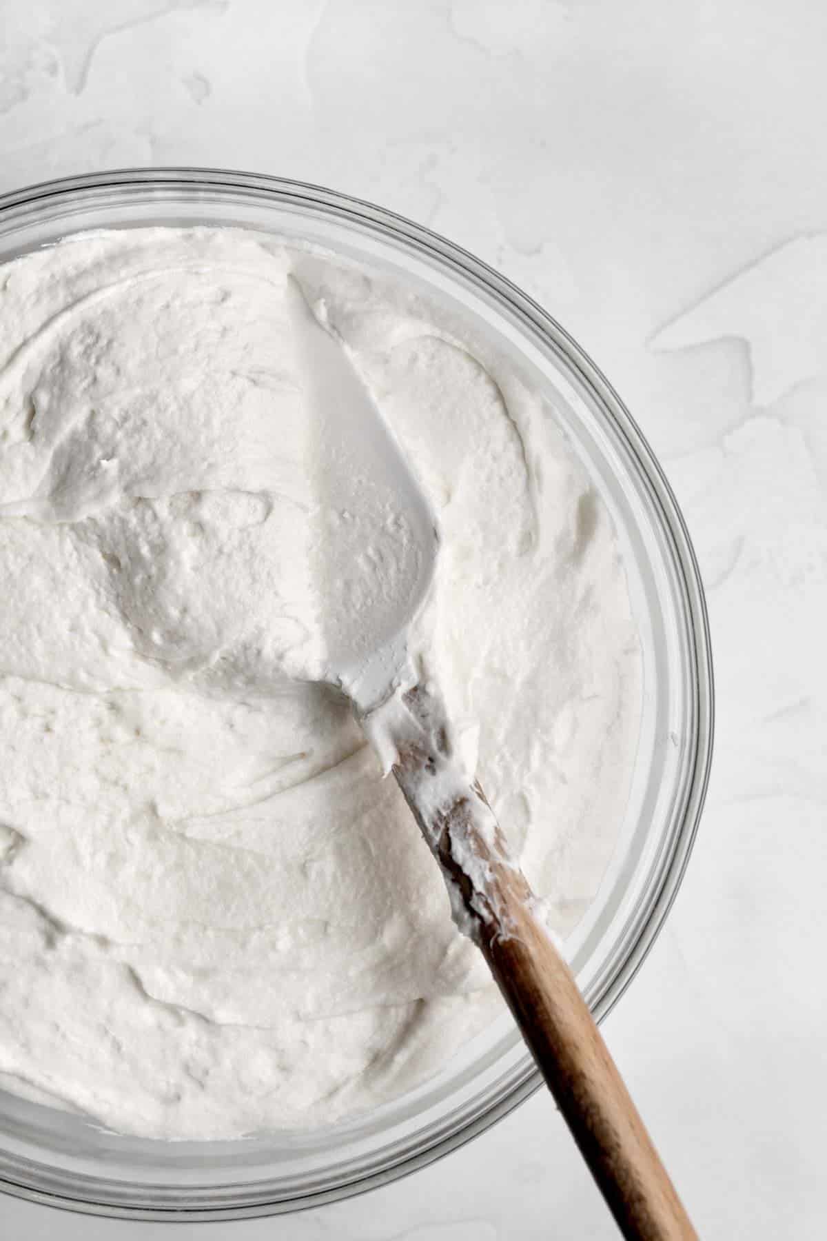 A bowl of smooth and creamy vegan vanilla frosting.