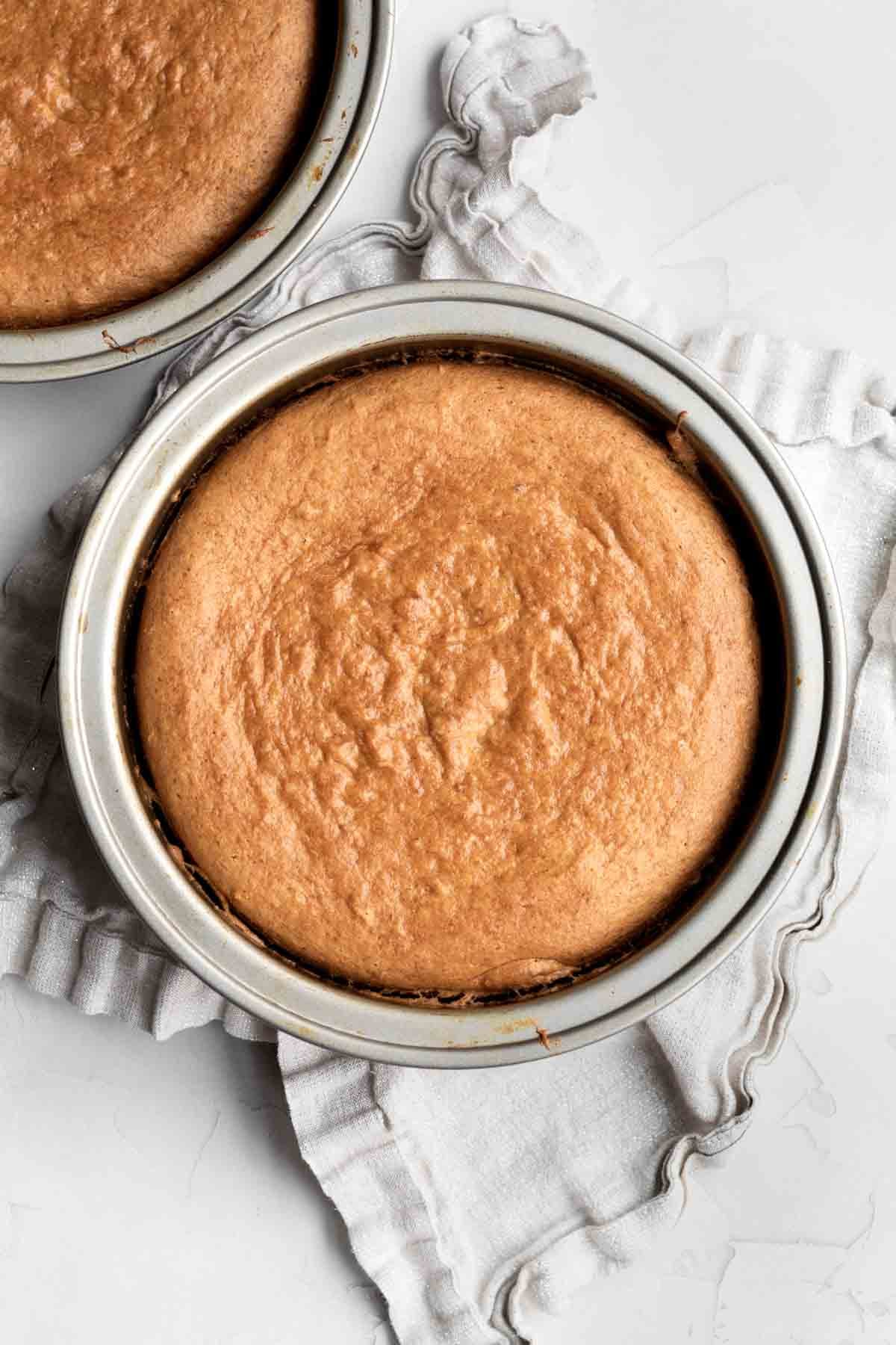 fresh, golden-brown, baked, gluten free banana cake bases in tins.