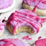 a bite reveals the tender brown sugar cookie beneath tangy blueberry cream cheese frosting and glaze.