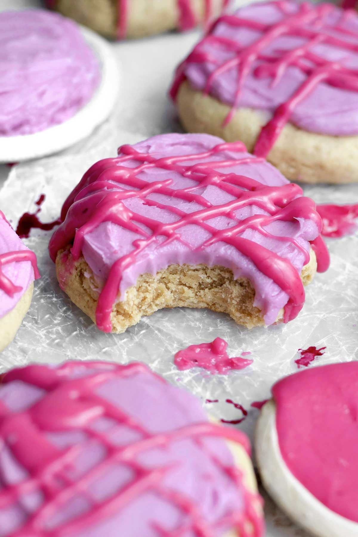 a bite reveals the tender brown sugar cookie beneath tangy blueberry cream cheese frosting and glaze.