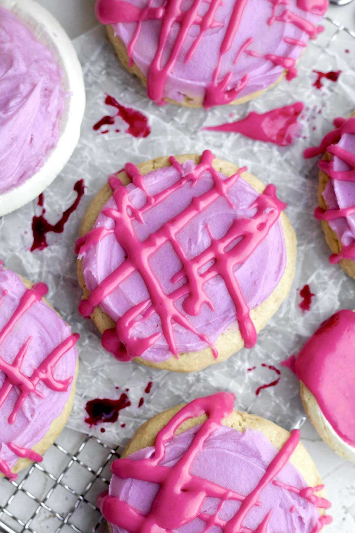 bright blueberry icing tops the brown sugar cookies with blueberry cream cheese frosting in a crosshatch pattern.
