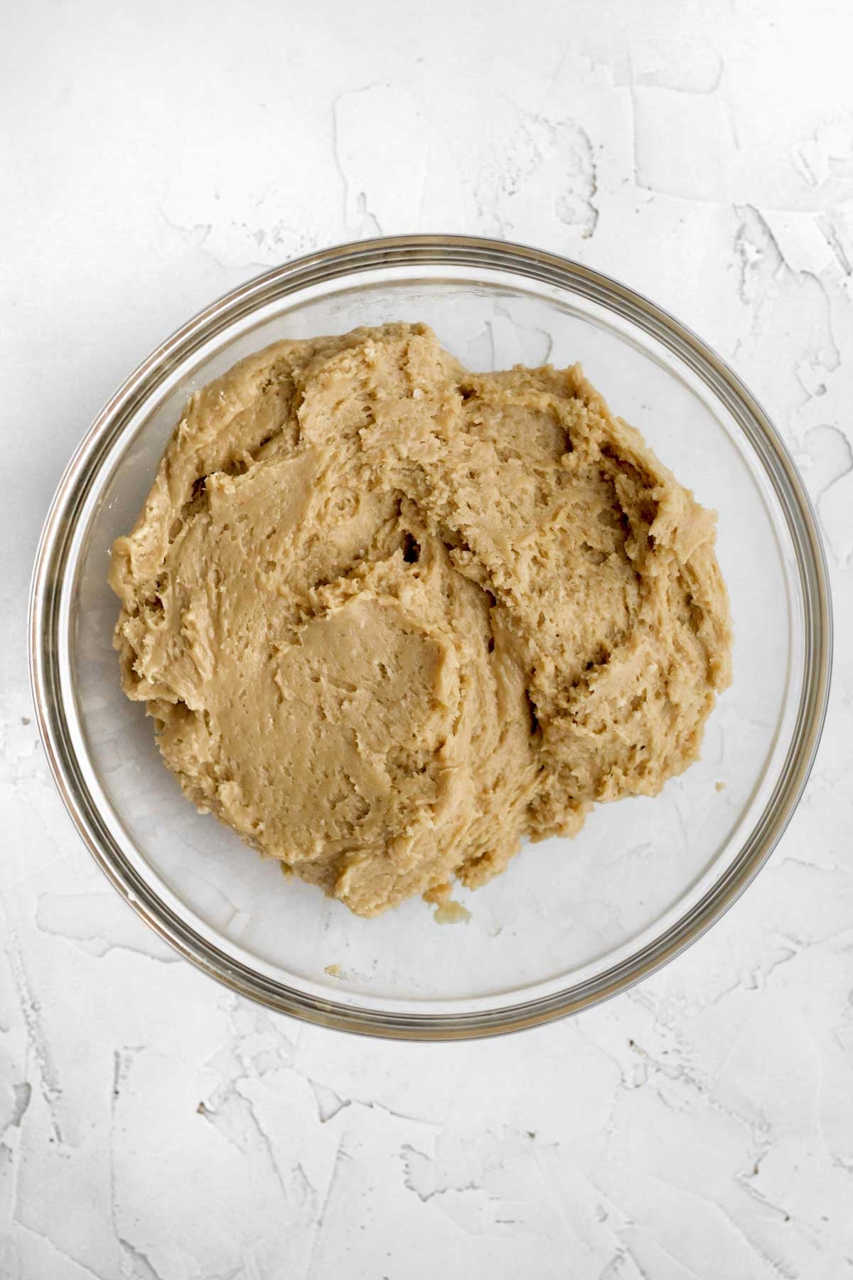 mixing the wet and dry ingredients into a brown sugar cookie batter.