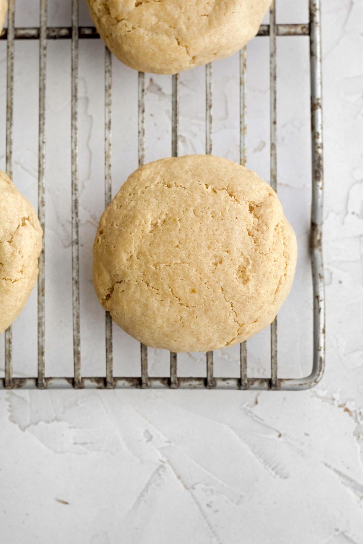 fresh-baked brown sugar cookie bases resting on a wire baking rack.