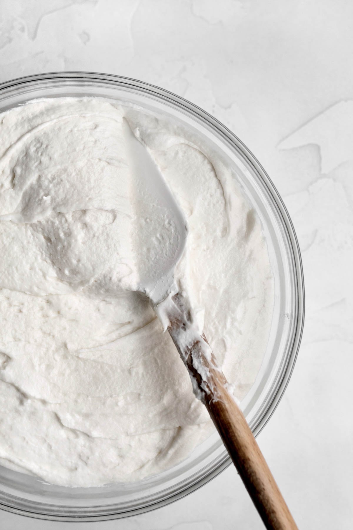 a bowl of creamy white vanilla frosting.