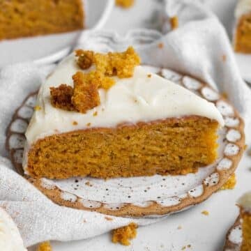 slice of moist easy carrot cake with its vibrant orange crumb and sweet cream cheese frosting.