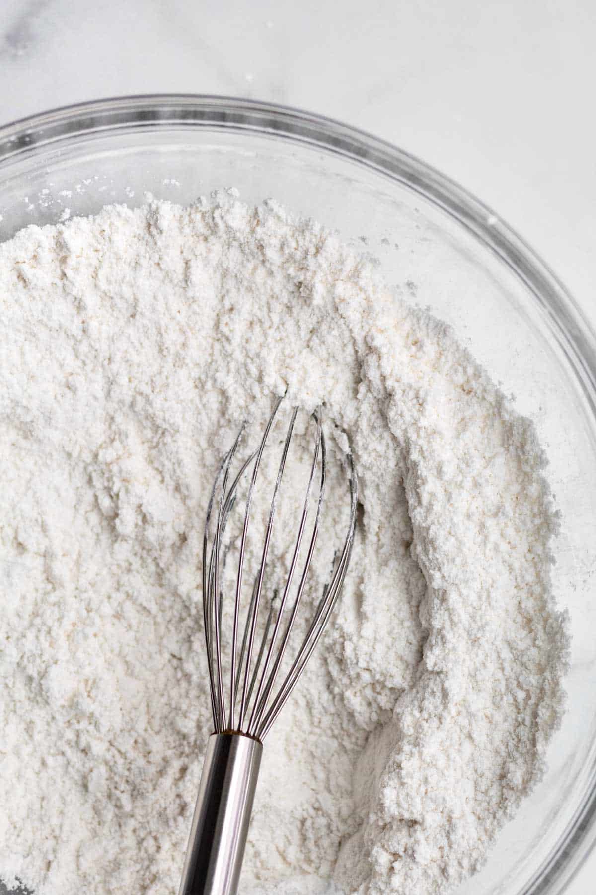 a whisk with the white dry ingredients.