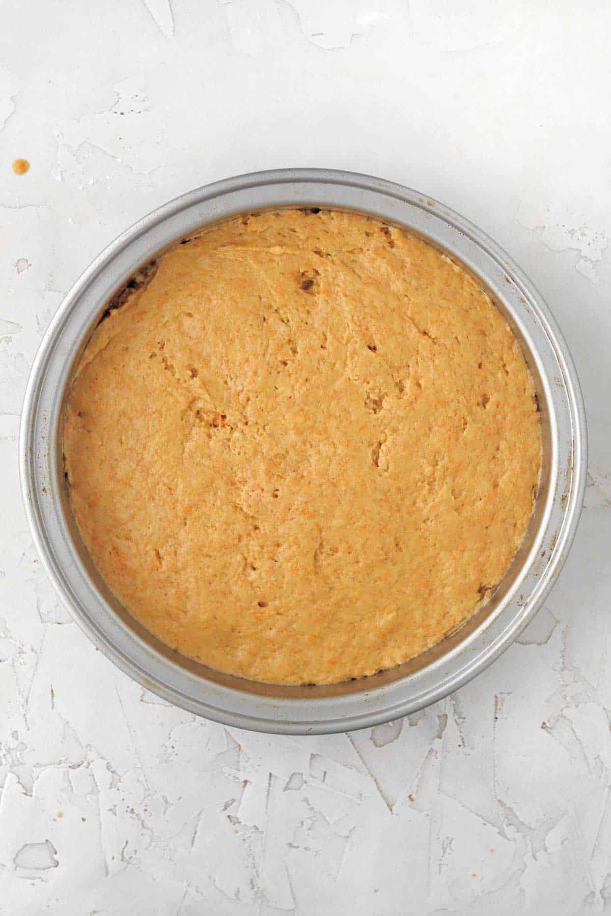 filling a cake tin with the easy carrot cake batter.
