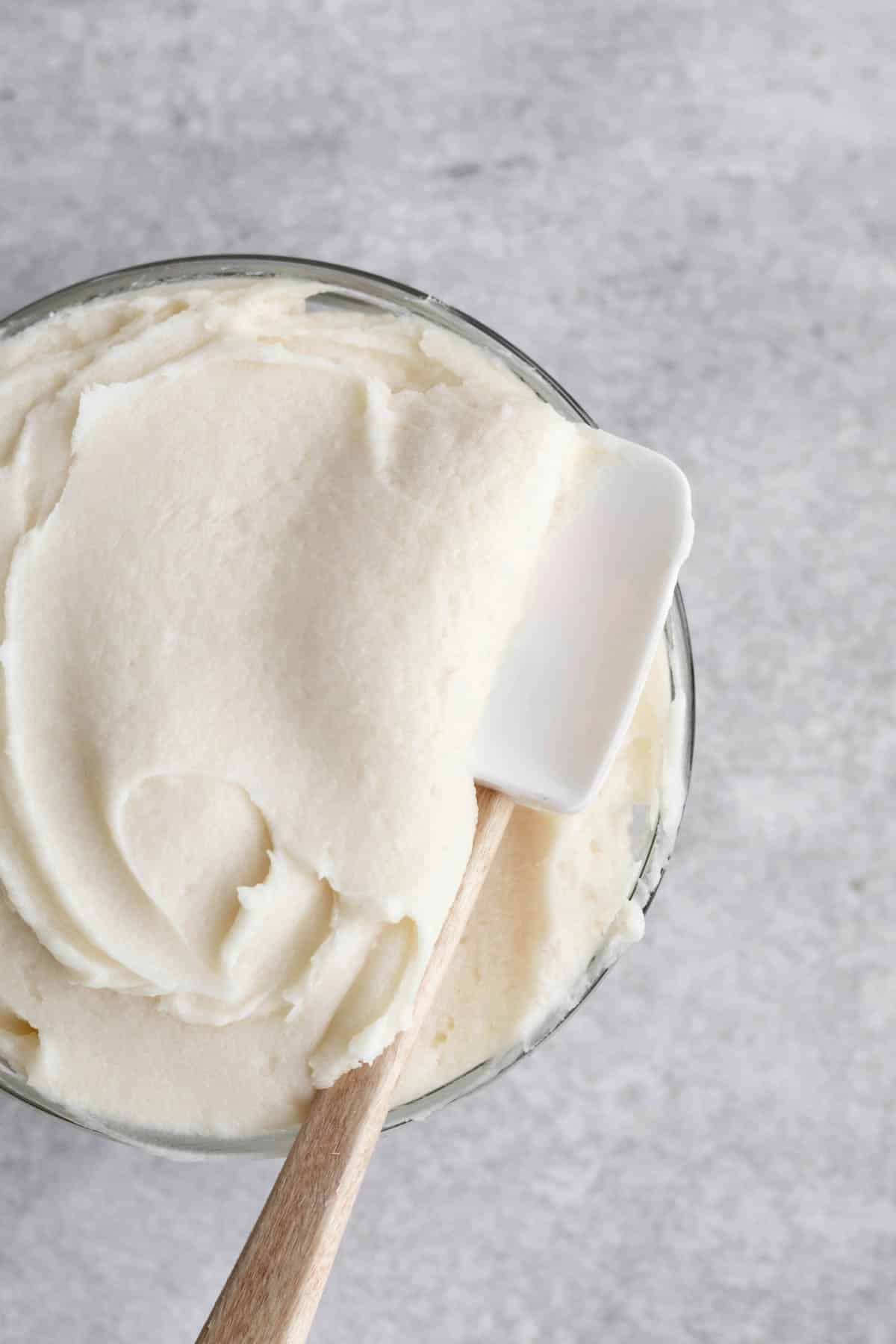 smooth and sweet cream cheese frosting in a bowl with a spatula.