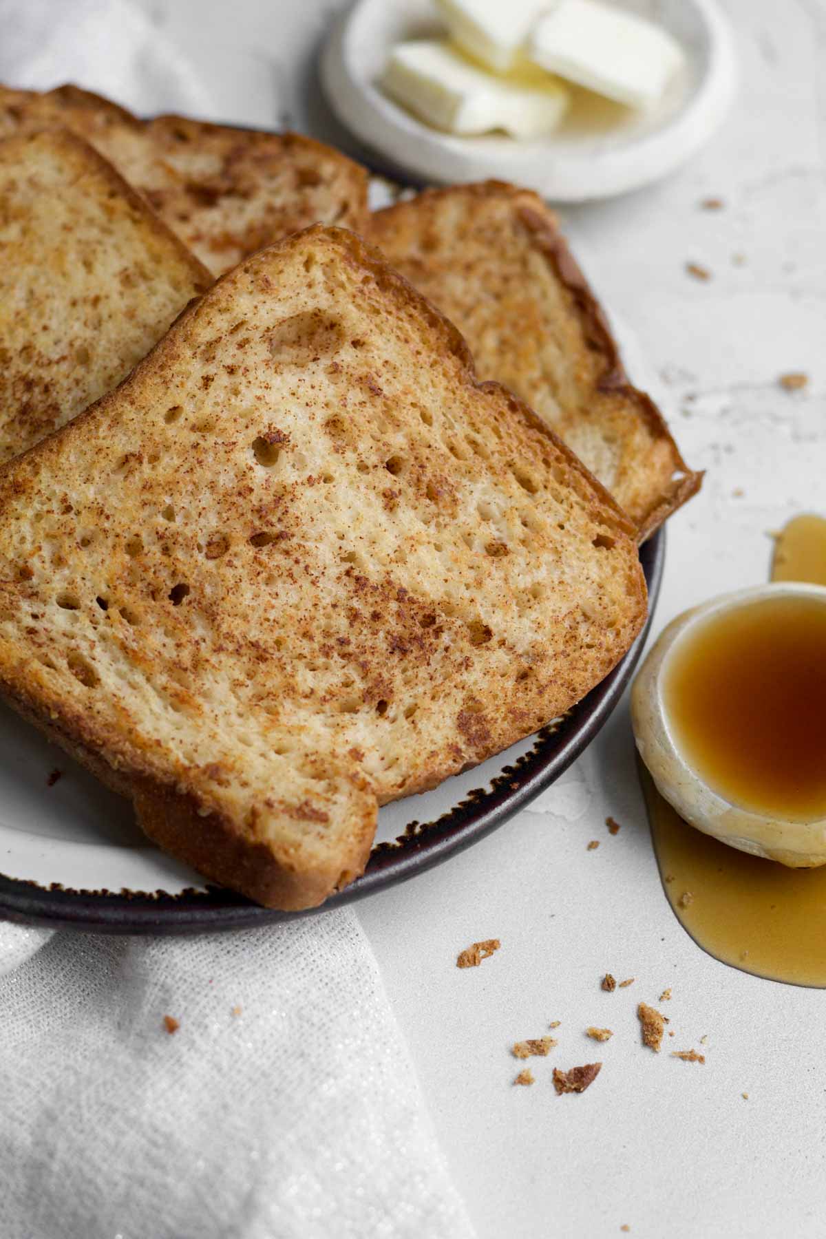 warm, gluten-free, golden-brown slices of easy no egg french toast on a plate.