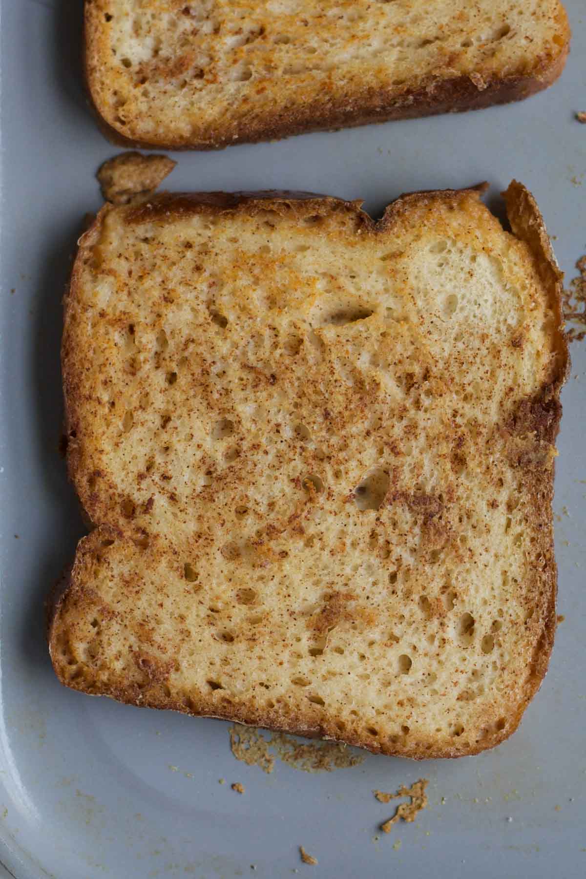 flipping the golden-brown toast on the pan.