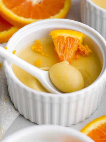 velvety orange posset with a creamy, sweet, perfect spoonful scooped out.