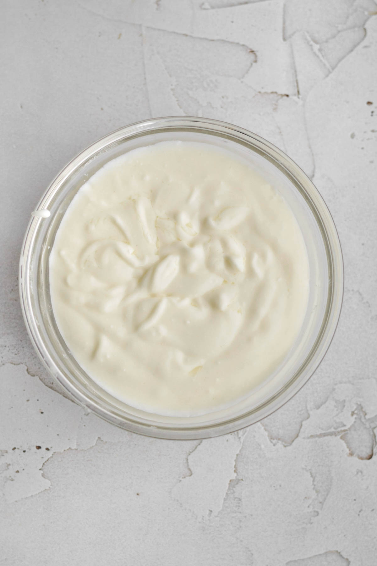 butter and cream cheese melted and mixed in a bowl.