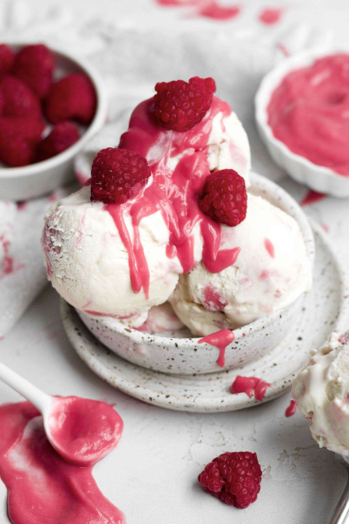 three delicious scoops of raspberry ripple ice cream topped with luscious raspberry curd and fresh raspberries.
