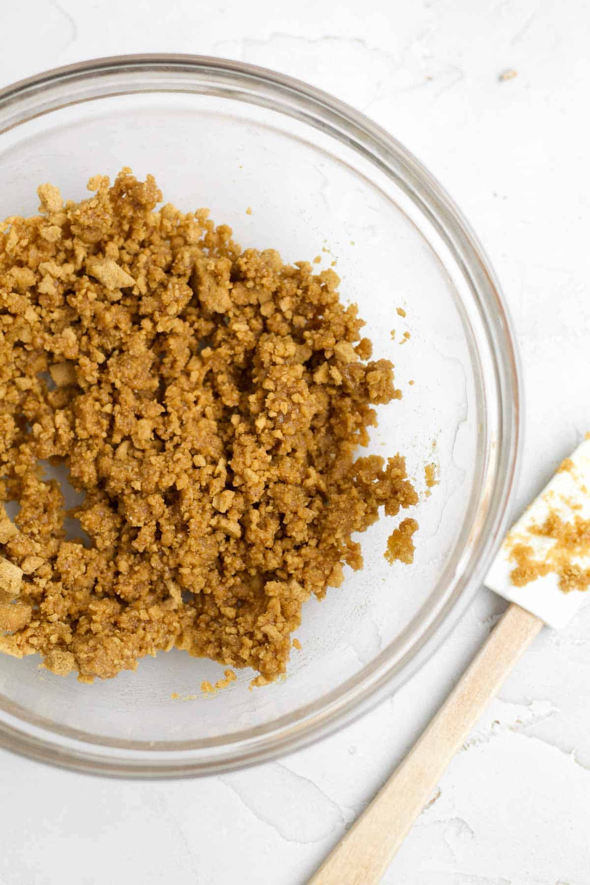 mixing in graham crackers into the melted butter.