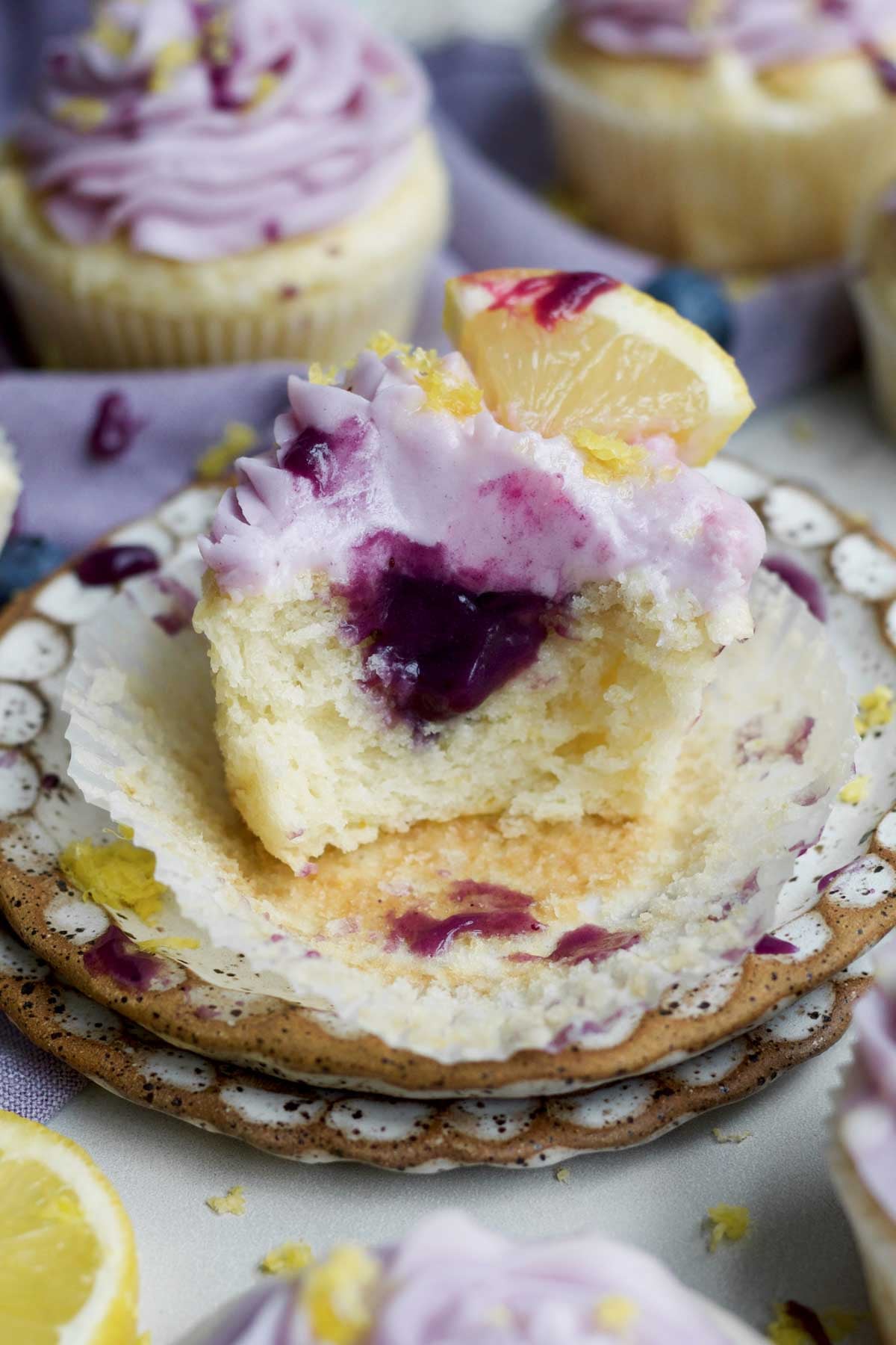 Inside the soft, gluten-free, lemon blueberry cupcake holds a reserve of sweet deep purple blueberry curd.
