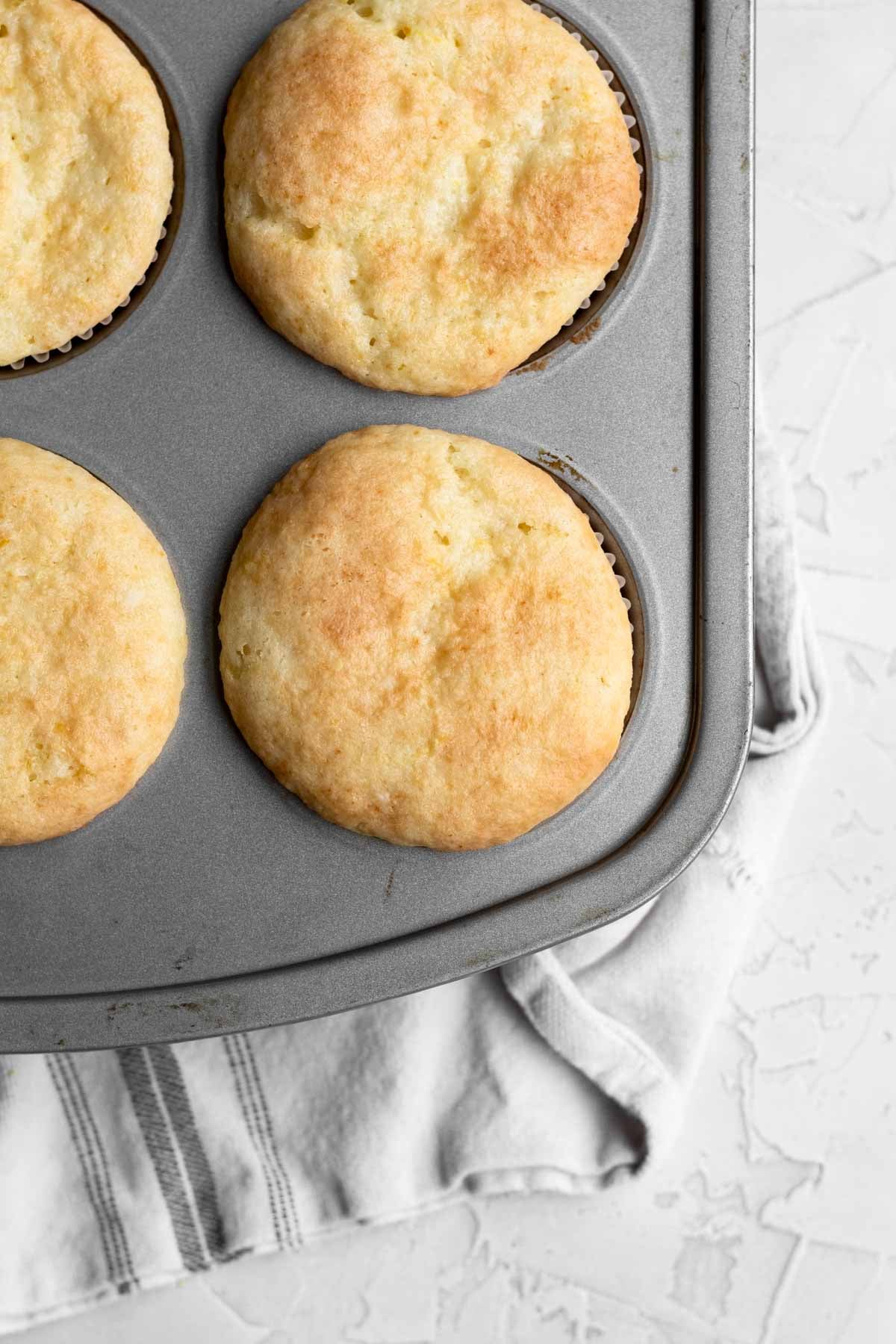 Fresh-baked golden-brown cupcakes risen from the tin.