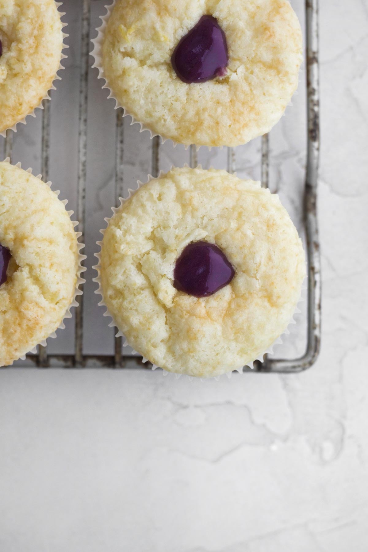Filling the centers of the cupcakes with delicious blueberry curd.
