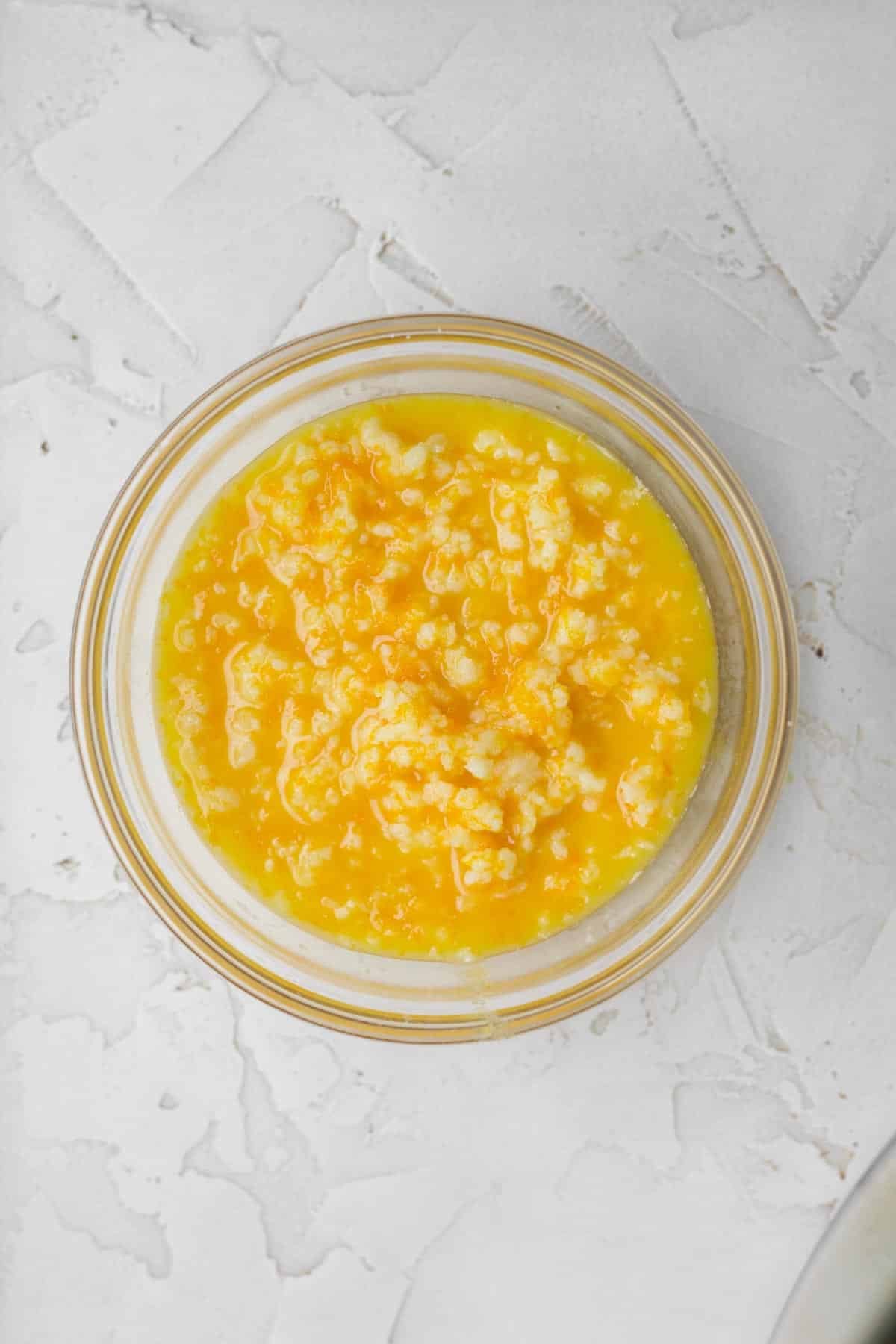 mixing the wet ingredients and orange zest into the butter.