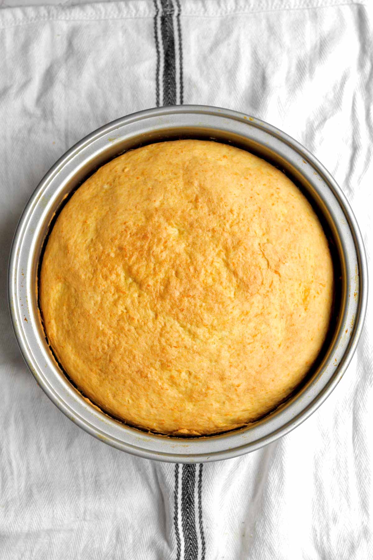 golden-brown, fresh-baked orange cake in a pan.