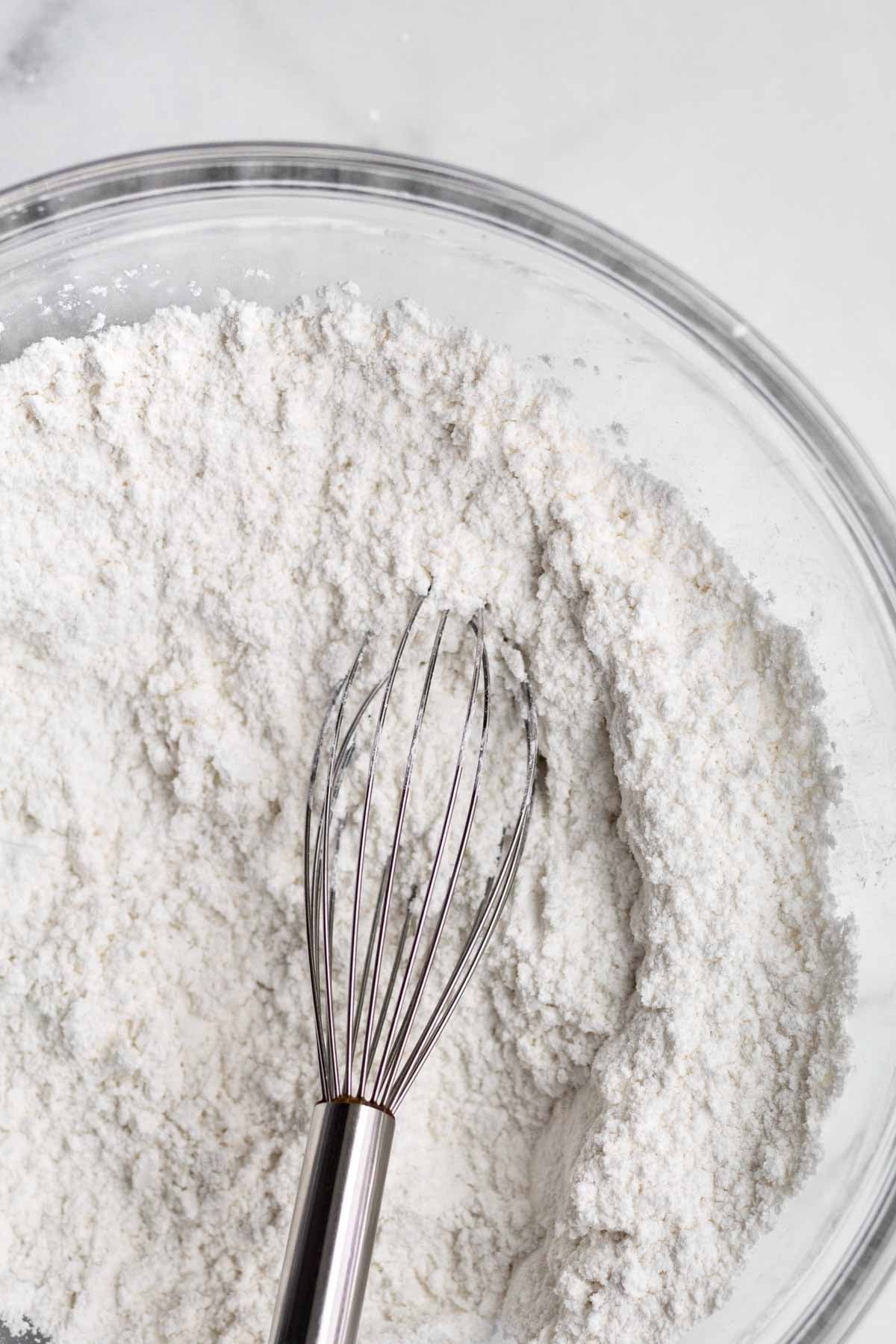 A whisk with the white dry ingredients.