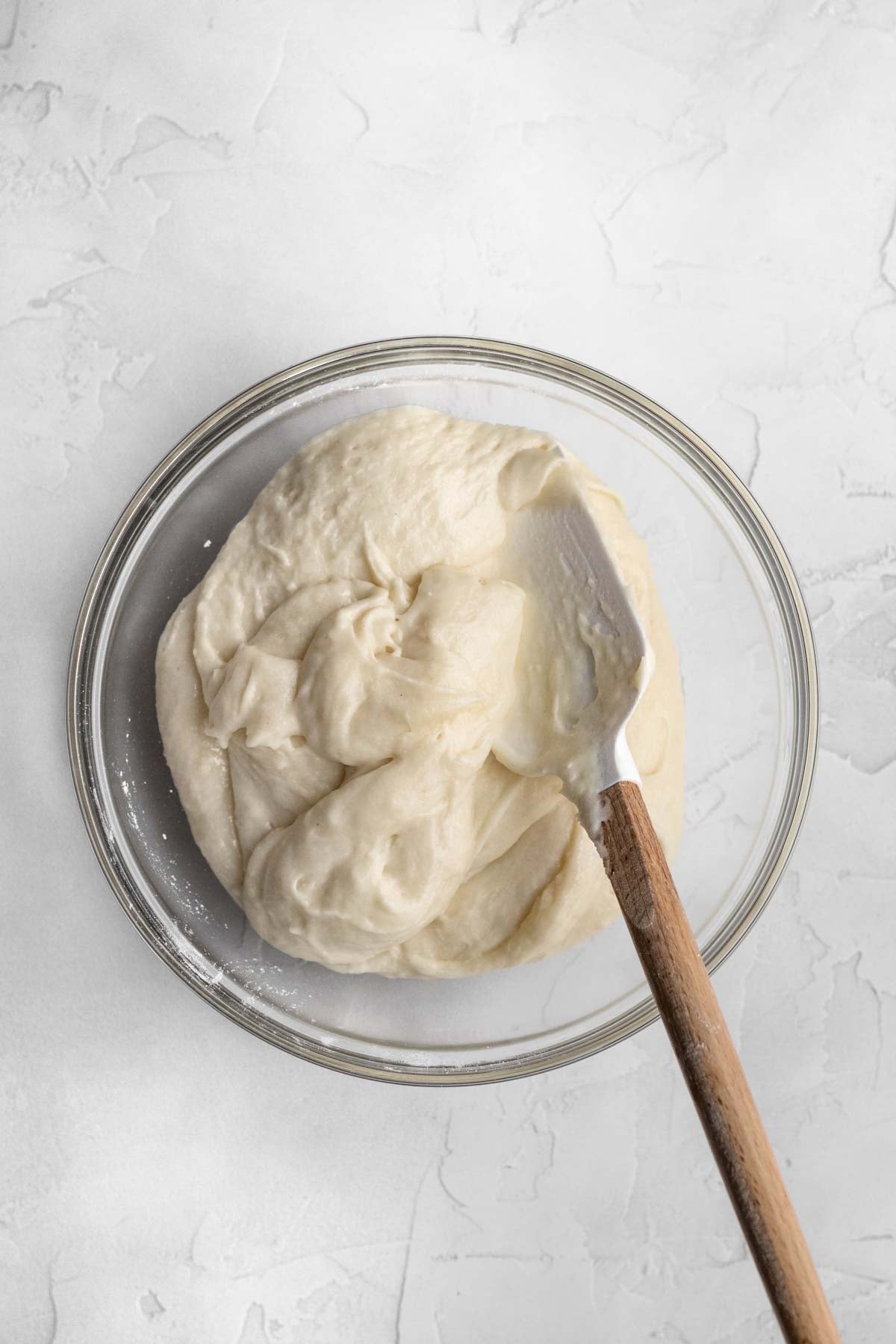 Mixing the wet and dry ingredients into a batter.