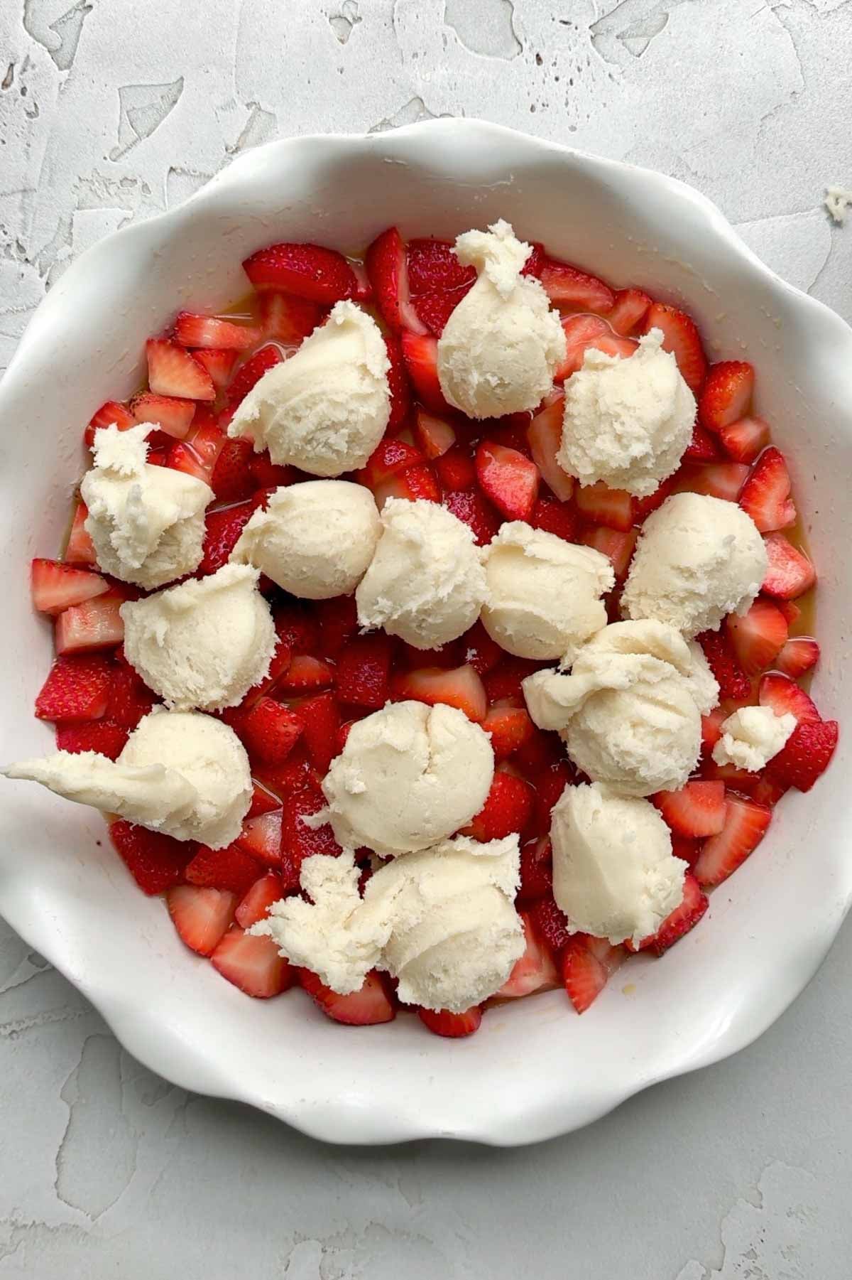 Scooping the batter onto the strawberries.