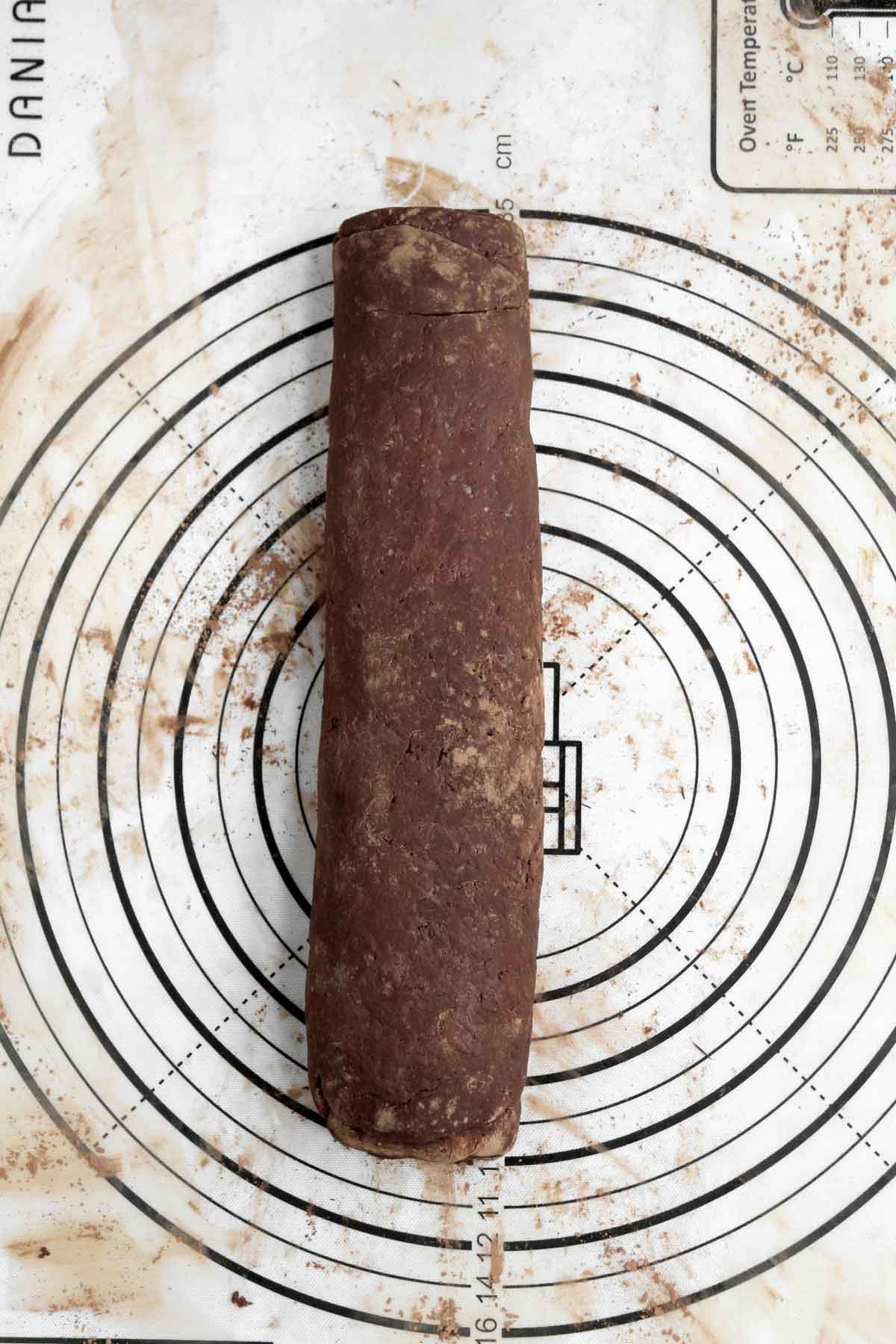 Rolling to dough up into a log chocolate log.