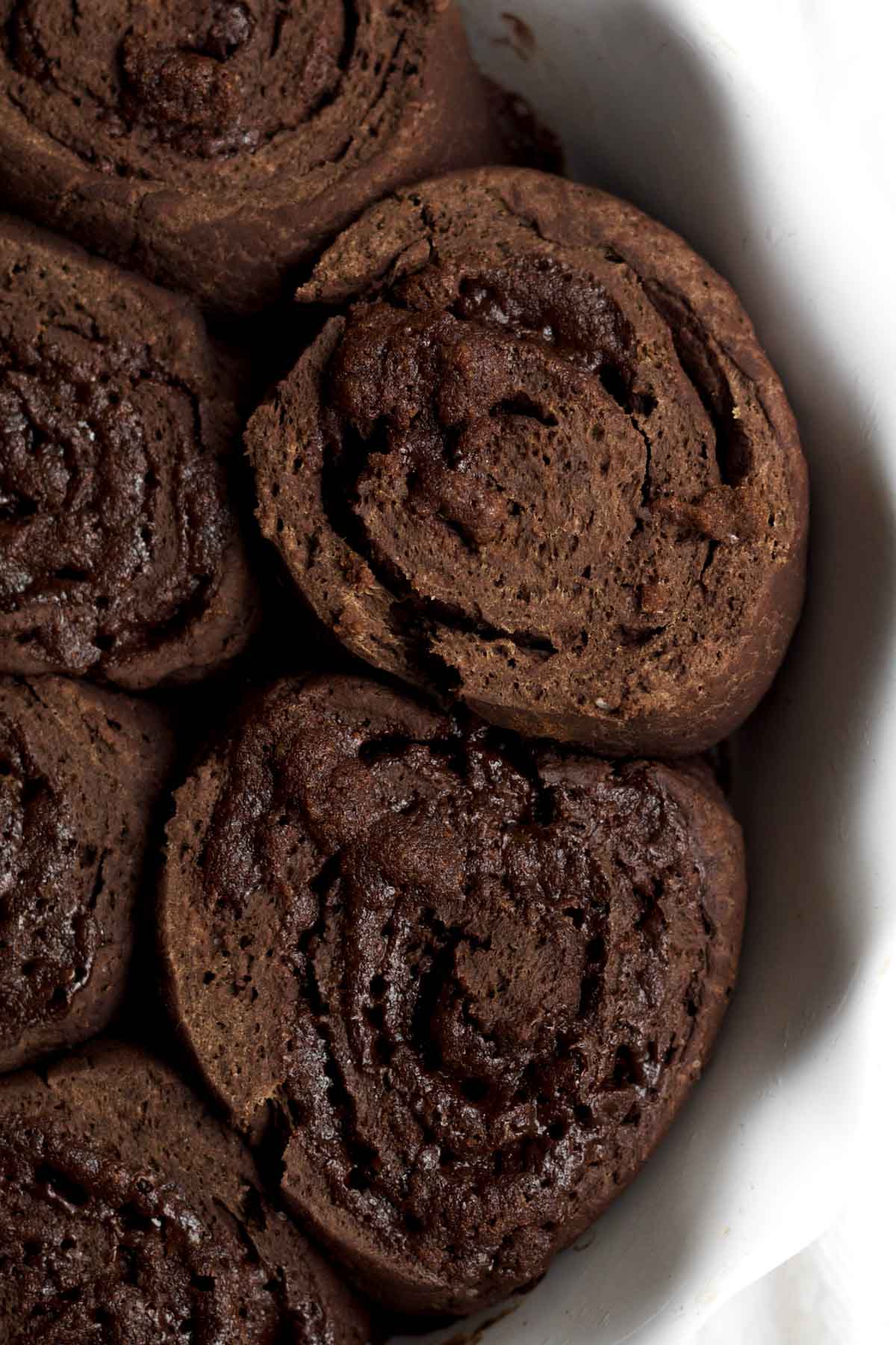 warm fresh-baked chocolate cinnamon rolls in a dish.