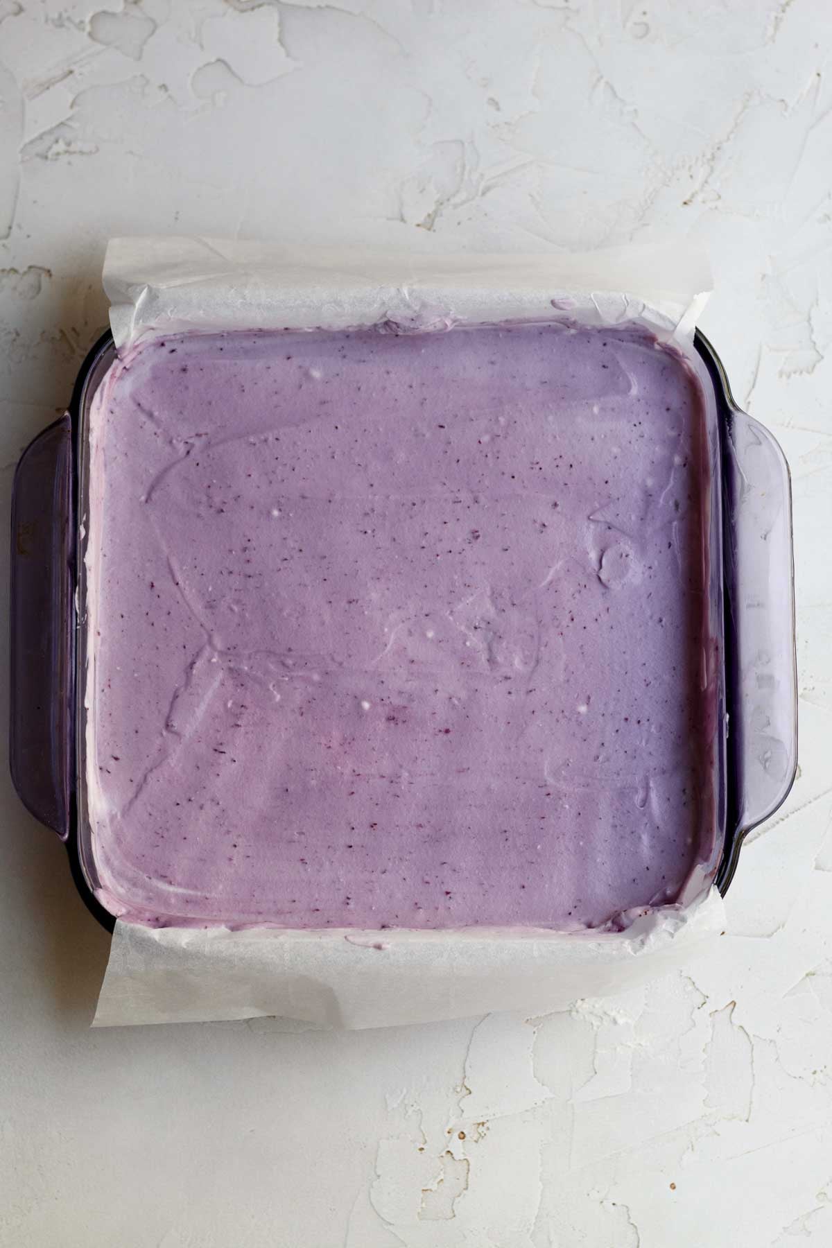 Adding the lavender top layer to the fudge and smoothing it out.